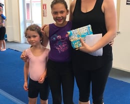 The girls presenting Amelia with a thank you gift